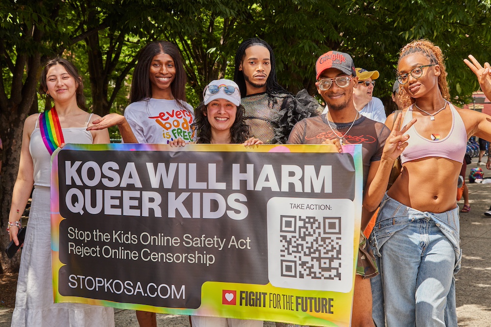 A group of young people hold a sign that reads "KOSA will harm queer kids" at a Pride event in Brooklyn