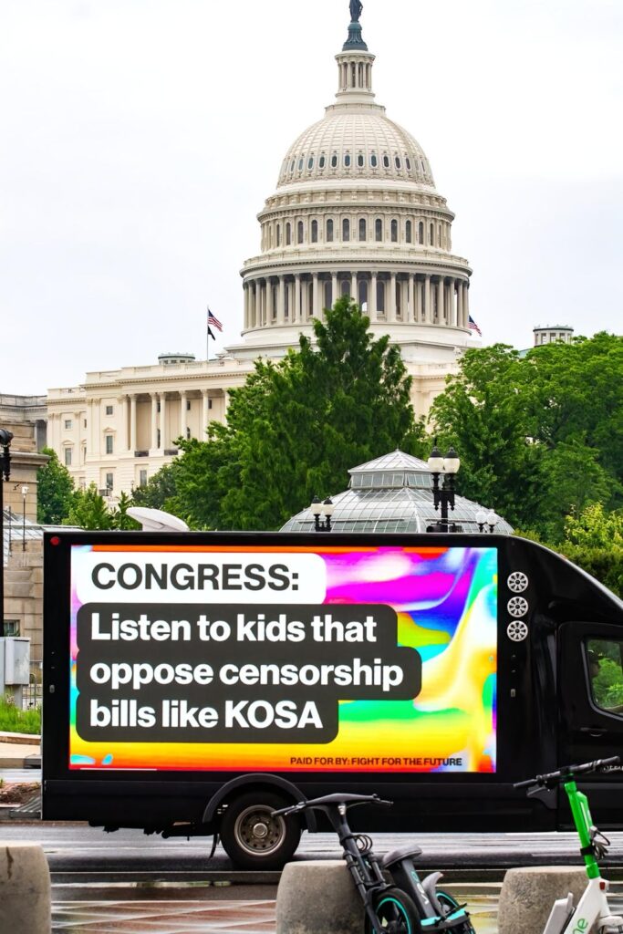 A screenshot of a TikTok video. It shows a truck with a digital billboard that reads "CONGRESS: Listen to kids that oppose censorship bills like KOSA"